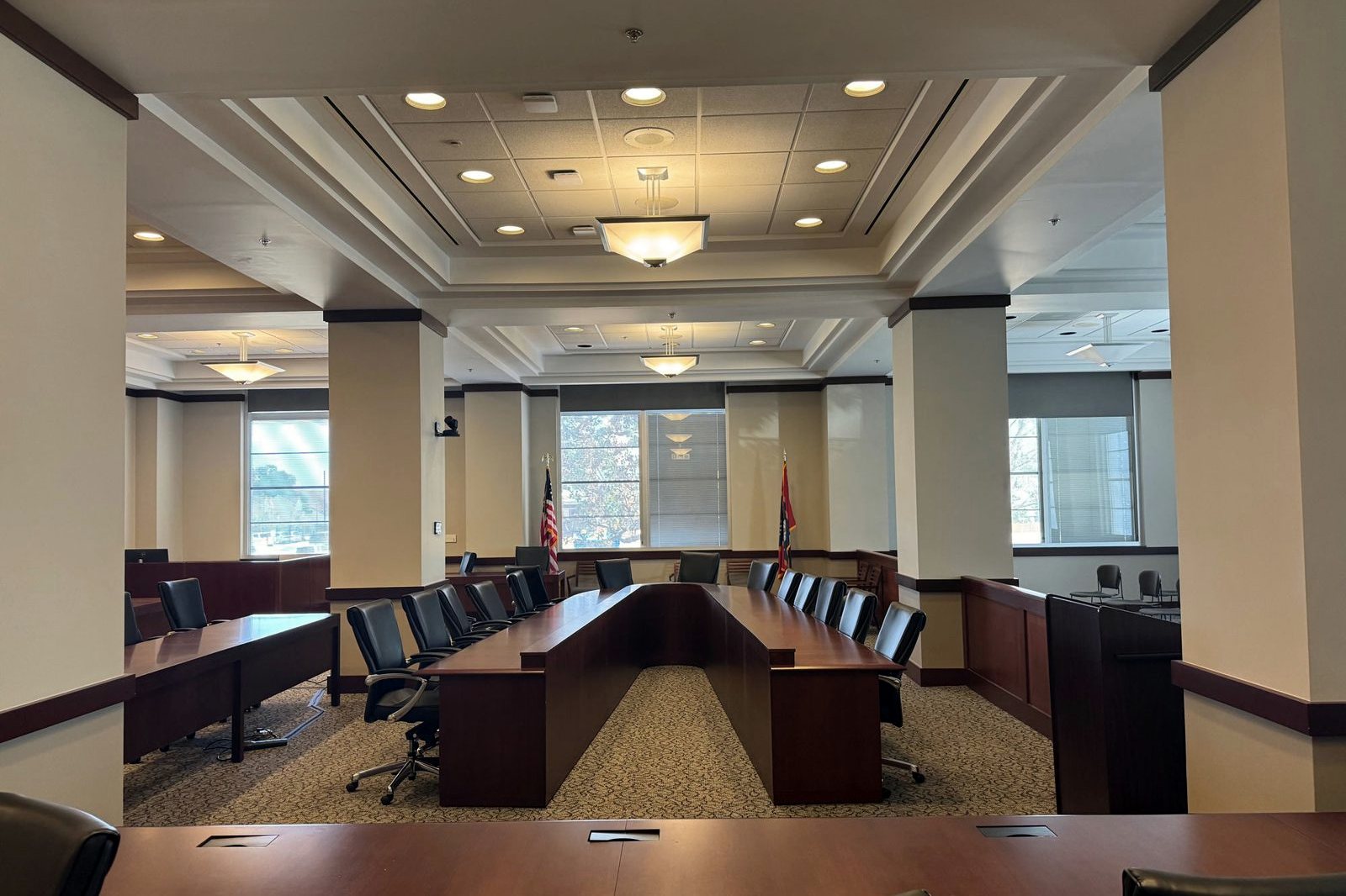Hearing room in the Woolfolk Building with painted columns, ceiling soffits, and wood millwork