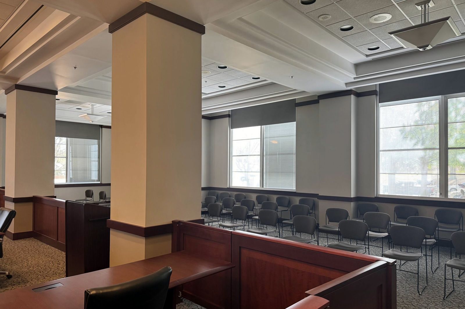 Hearing room gallery with painted columns, walls, and window surrounds